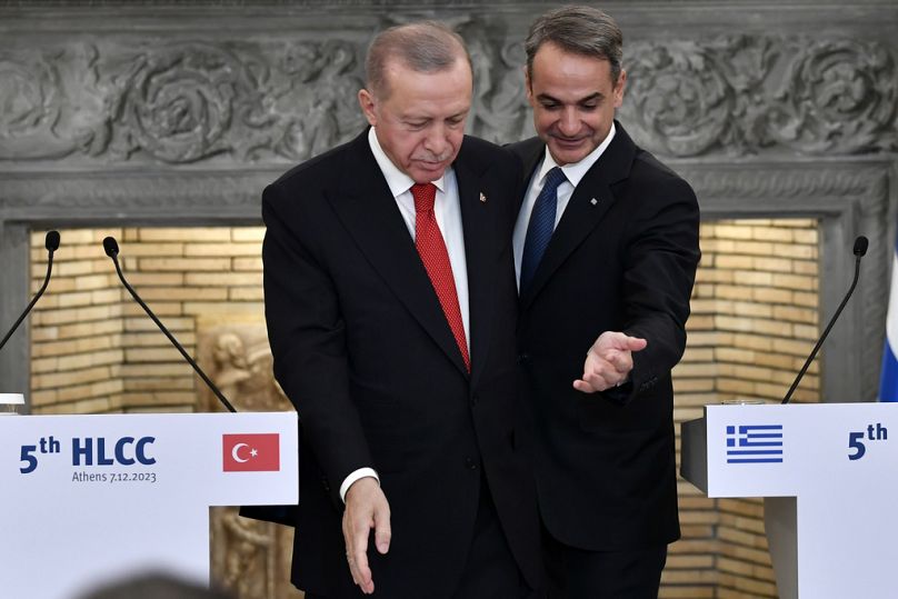 Greece's PM Kyriakos Mitsotakis and Turkish President Recep Tayyip Erdogan leave after their statements at Maximos Mansion in Athens, December 2023