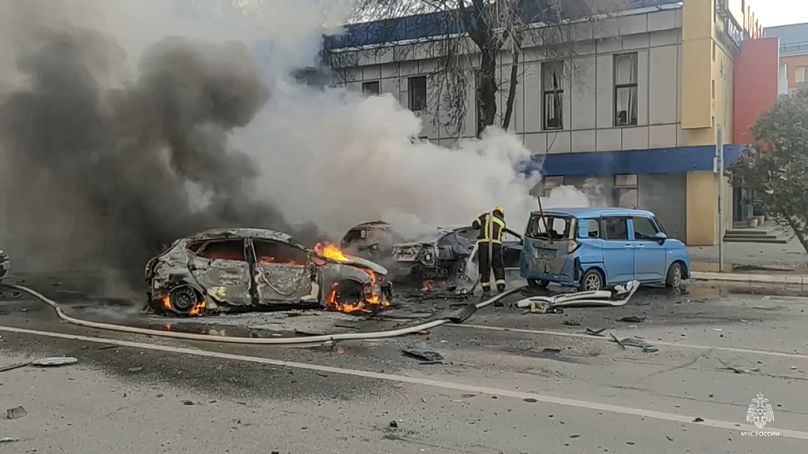 Firefighters extinguish burning cars after shelling in Belgorod, Russia. Russian officials have accused Ukrainian forces of shelling the border city.