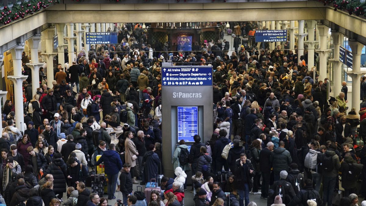 Passengers wait on the concourse at the entrance to the Eurostar in St Pancras International station, central London on Saturday