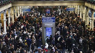 Passengers wait on the concourse at the entrance to the Eurostar in St Pancras International station, central London on Saturday