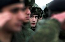 FILE - In this Monday, Nov. 17, 2014, file photo, conscripts stand at a military conscription office in Grozny, Chechnya's provincial capital.