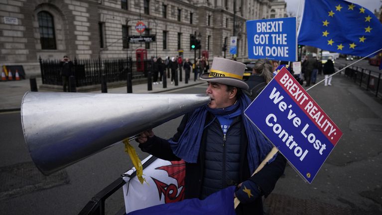 Anti-Brexit protester Steve Bray demonstrates on the edge of Parliament Square across the street from the Houses of Parliament, in London, Wednesday, Dec. 8, 2021.