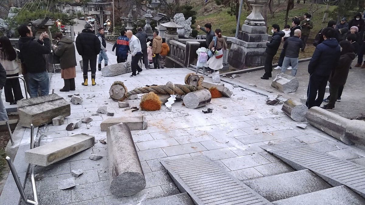 Japan lowers tsunami warning but advises against returning home after