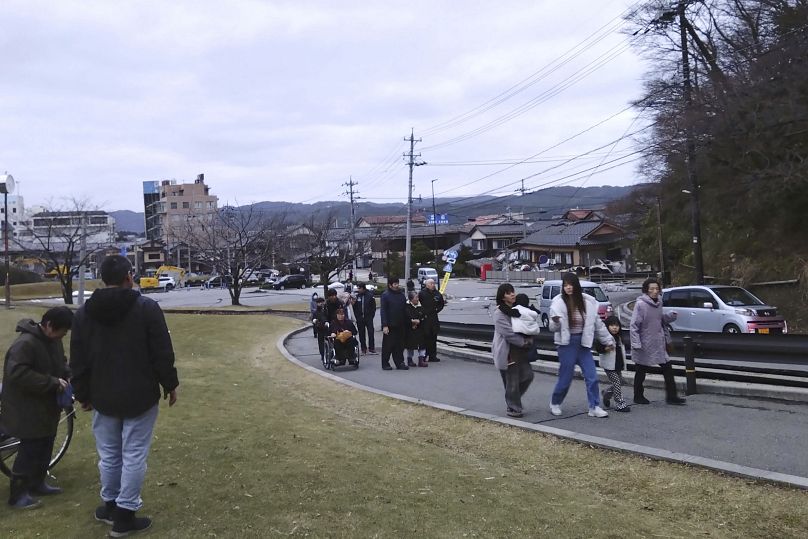 People walk to a higher place to take shelter after an earthquake in Wajima, Ishikawa prefecture.