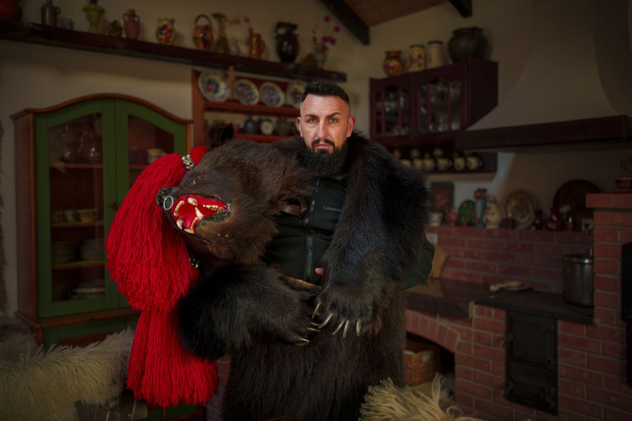 Marian, 35 years-old, a member of the Sipoteni bear pack, poses for a portrait in Comanesti, northern Romania, Wednesday, Dec. 27, 2023.
