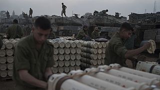 Israeli soldiers from the artillery unit store tank shells in a staging area at the Israeli-Gaza border in southern Israel