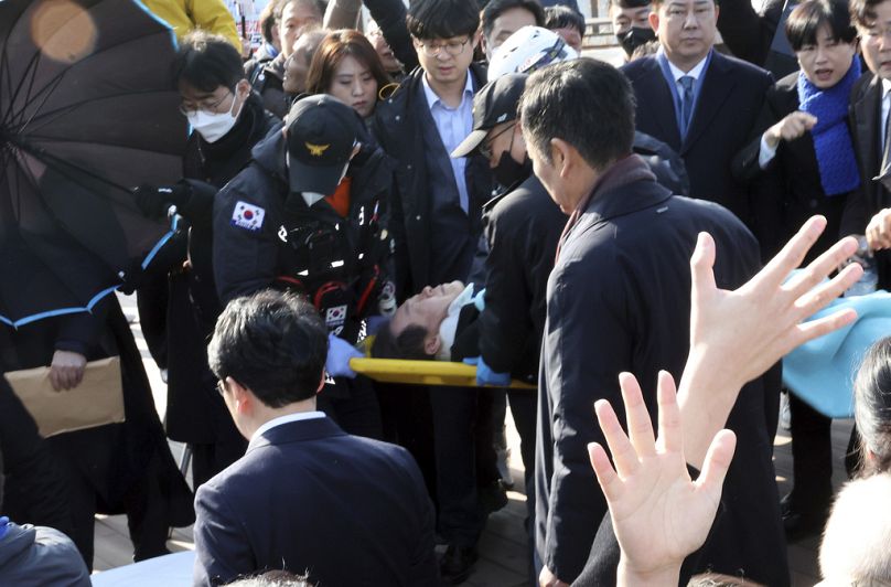 South Korean opposition leader Lee Jae-myung on a stretcher, is carried by rescue team in Busan, South Korea