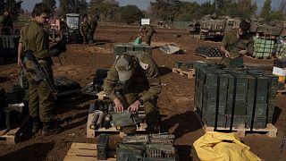 سربازان اسرائیلی در حال جابه‌جایی مهمات در منطقه‌ای در مرز نوار غزه در جنوب اسرائیل به تاریخ دوم ژانویه ۲۰۲۴