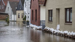 The flood waters of the Aller are still standing in a street in the old town of Verden, Germany, Monday, Jan. 1, 2024.