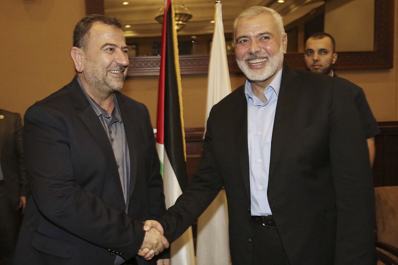Ismail Haniyeh, right, the head of the Hamas political bureau, shakes hands with his deputy Saleh Arouri, Aug. 2, 2018.