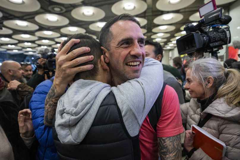 Spanish Santiago Sanchez Cogedor is welcomed by friends and family members at the Barajas airport, outskirts of Madrid.