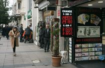Peple walk next to an exchange currency shop in Istanbul, Turkey, Thursday, Dec. 21, 2023. Turkey's central bank hiked its key interest rate by 2.5 percentage points on Thursd
