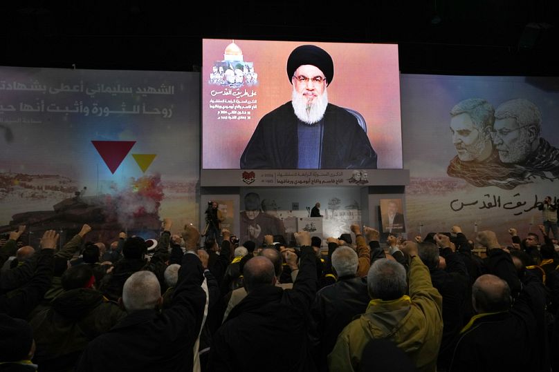 Supporters of the Iranian-backed Hezbollah group listen to a speech by Hezbollah leader Sayyed Hassan Nasrallah speaking during a ceremony in the suburbs of Beirut, Jan 3 2024