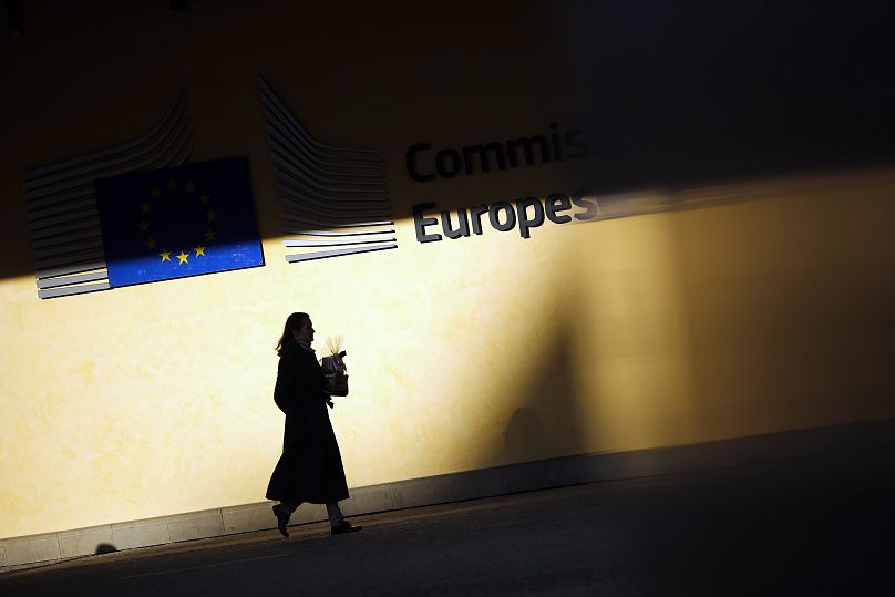 A woman walks outside the European Commission headquarters in Brussels, November 2019