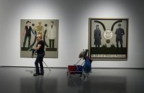 Two works by Polish artist Ignacy Czwartos on display at a 2021 exhibition. The painting on the right reads “German Mothers, German Fathers, Death Is A Master From Germany".