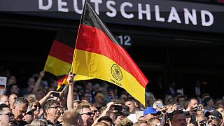 Germany's fans hold a flag during a friendly soccer match between Germany and Ukraine in Bremen, Germany, Monday, June 12, 2023. It is the 1000st match for the German national