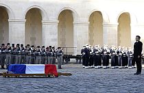 French President Emmanuel Macron honors the coffin of late French politician and former European Commission President Jacques Delors in the courtyard of the Hotel des Invalide