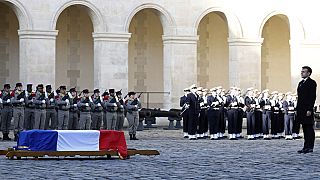 French President Emmanuel Macron honors the coffin of late French politician and former European Commission President Jacques Delors in the courtyard of the Hotel des Invalide