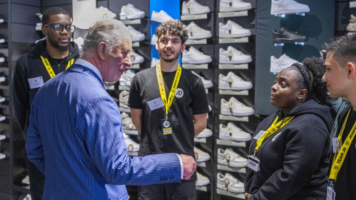 Britain's Prince Charles visits a JD Sports store in London, Wednesday May 11, 2022, to meet young people supported by The Prince's Trust through the UK Government's Kickstart