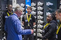 Britain's Prince Charles visits a JD Sports store in London, Wednesday May 11, 2022, to meet young people supported by The Prince's Trust through the UK Government's Kickstart