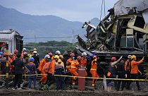 Rescuers remove the body of a train crash victim in Cicalengka, West Java, Indonesia, Friday, Jan. 5, 2024.