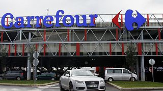A car leaves a Carrefour supermarket in Anglet, southwestern France
