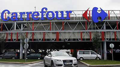 A car leaves a Carrefour supermarket in Anglet, southwestern France