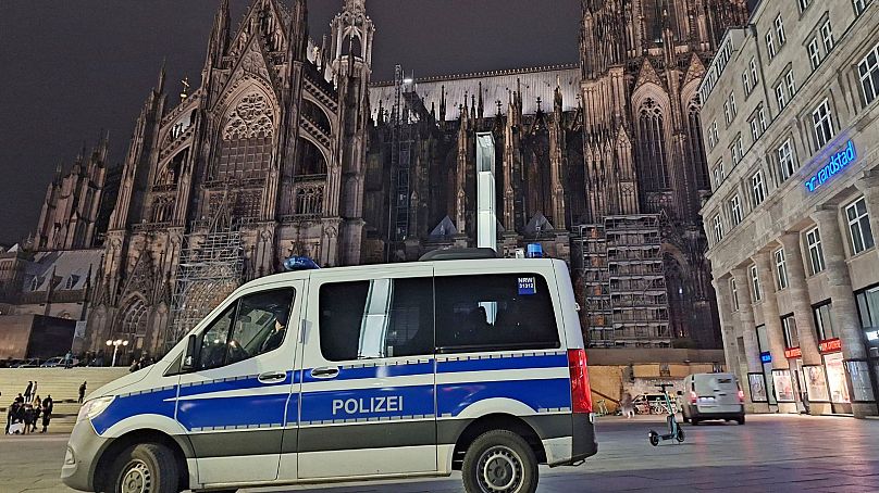 Un vehículo de la policía está estacionado frente a la catedral en Colonia, Alemania, el sábado 23 de diciembre. 2023.