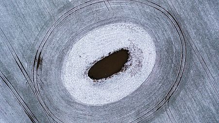 A thin layer of snow lies on a field around a so-called "Soll", in Rehna, Germany, Friday Jan. 5, 2024. Solls often formed as a result of an ice age in north-eastern Germany. 