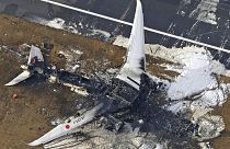 This aerial photo show the burn-out Japan Airlines plane at Haneda airport on Wednesday, January 3, 2024, in Tokyo, Japan.
