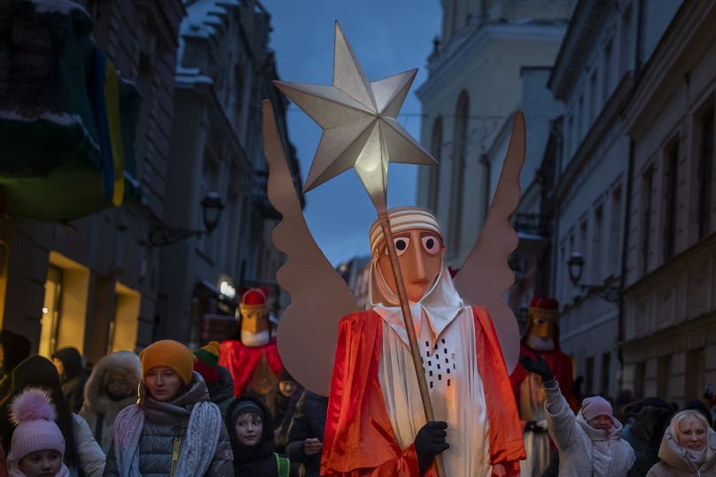 People parade through the streets as part of celebrations of Three Kings Day in Vilnius, Lithuania, Saturday, Jan. 6, 2024.