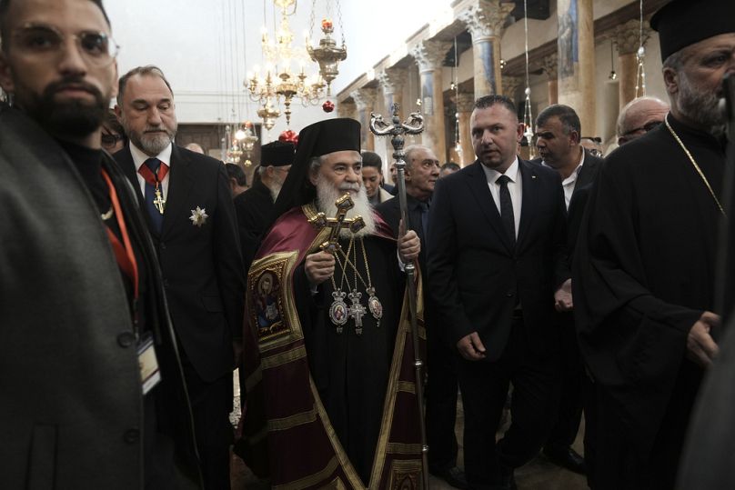 Greek Orthodox Patriarch of Jerusalem Teophilos III walks in the Nativity Church, where Christians believe Jesus Christ was born.
