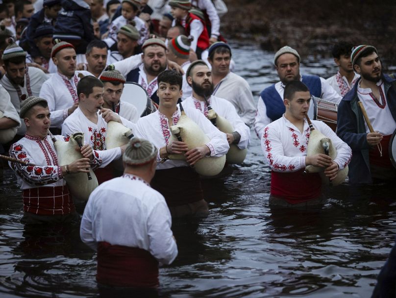 Men play bagpipes and drums as they wade into the cold Tundzha River to celebrate Epiphany, in the town of Kalofer, Bulgaria.