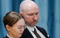 Anders Behring Breivik and attorney Marte Lindholm sits, as the Oslo district court conducts his case in a gymnasium at Ringerike prison, in Ringerike, Norway, Monday, Jan. 8,