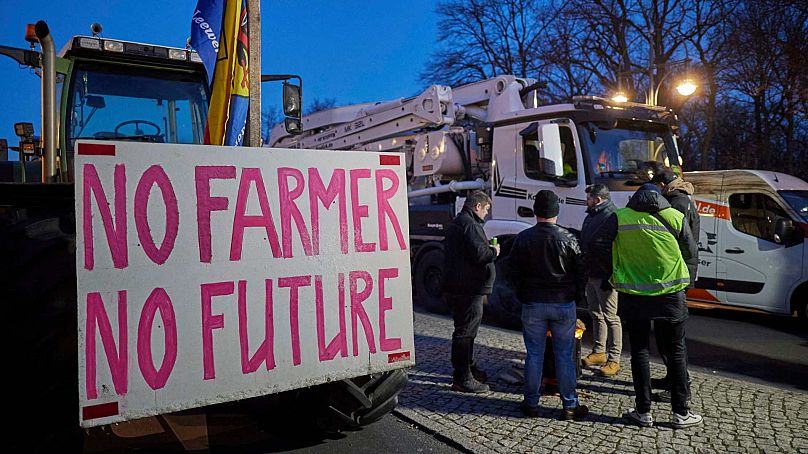 "No Farmer, no Future" is written on a sign attached to one of the tractors at a farmers' protest on Stra'e des 17. Juni in front of the Brandenburg Gate in Berlin, Germany.