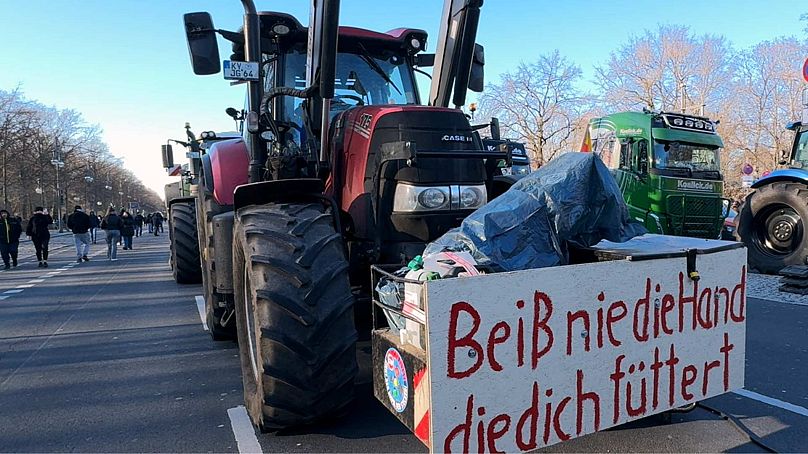 A tractor with a sign that reads 'Never bite the hand that feeds', Berlin, 8 January 2024