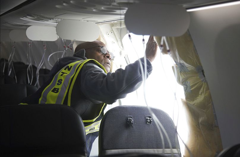 This photo released by the National Transportation Safety Board shows a gaping hole where the paneled-over door had been at the fuselage plug area of Alaska Airlines Flight