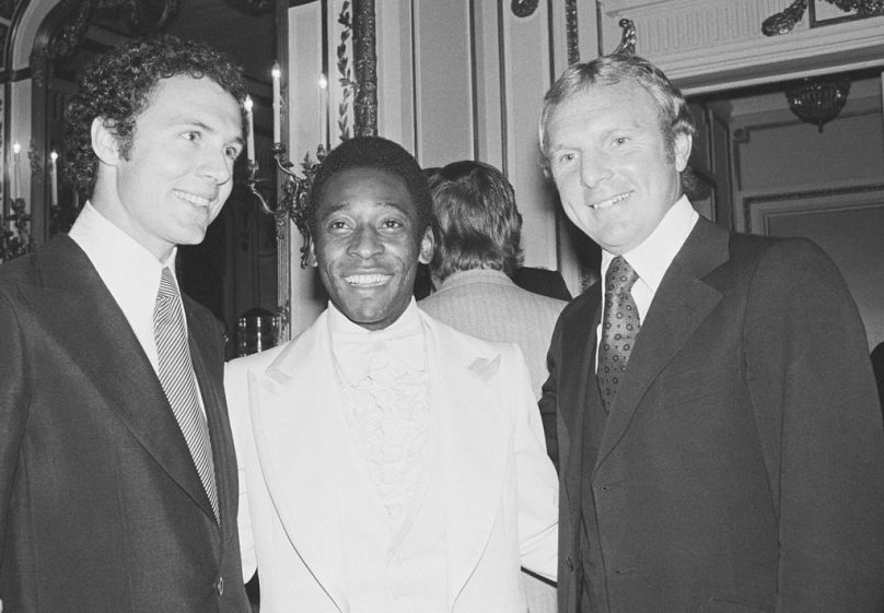 Captain of the 1974 World Cup team from West Germany, Franz Beckenbauer, left, Soccer star Pele, center, and Bobby Moore, captain of England's 1966 World Cup soccer team pose.
