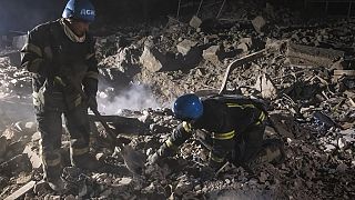 In this photo provided by the Ukrainian Emergency Service, firefighters examine the site of Russia's missile attack that hit an apartment building in Pokrovsk, Ukraine