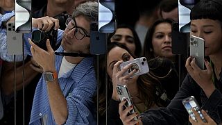 People take photos of the iPhone 15 Pro phones during an announcement of new products on the Apple campus in Cupertino, Calif., Tuesday, Sept. 12, 2023