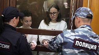 Theater director Zhenya Berkovich and playwright Svetlana Petriychuk stand in a glass cage in a courtroom prior to a hearing in a court in Moscow, Russia, 6 September, 2023.