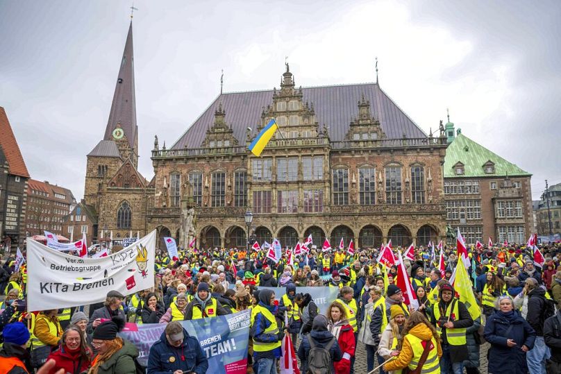 Protesters at Bremen's city hall during a DGB rally, urging better training in female-dominated fields and addressing the gender pay gap to combat skill shortages. March 2023