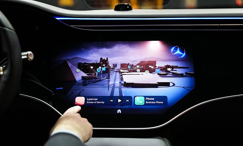 Vadim Weiss, Mercedes-Benz USA, gives a demonstration of the company's new operating system, MBOS 1, during the CES tech show in Las Vegas.