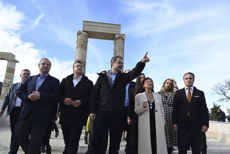Greece's Prime Minister Kyriakos Mitsotakis, centre, visits the Palace of Aigai on Friday 5 January 2024