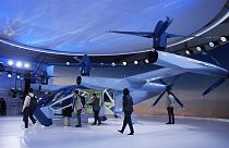 People look at the Supernal S-A2 passenger electric VOTL aircraft at the Supernal booth during the CES tech show Wednesday, January 10, 2024, in Las Vegas.
