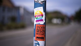 A sticker against Nazis and racism is displayed on a lamp pole near the Mina Witkojc school in Burg (Spreewald), Germany, Wednesday, July 19, 2023
