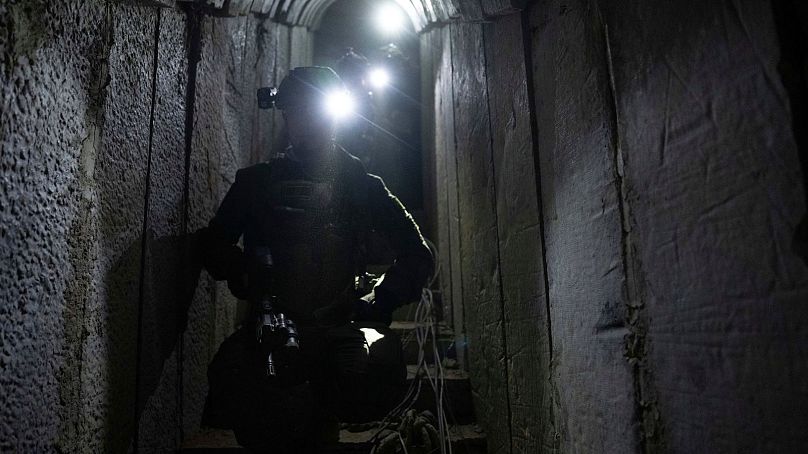 Israeli soldiers show journalists an underground tunnel where the Israeli military said it had found evidence hostages were held by militants in Khan Younis on Wednesday.