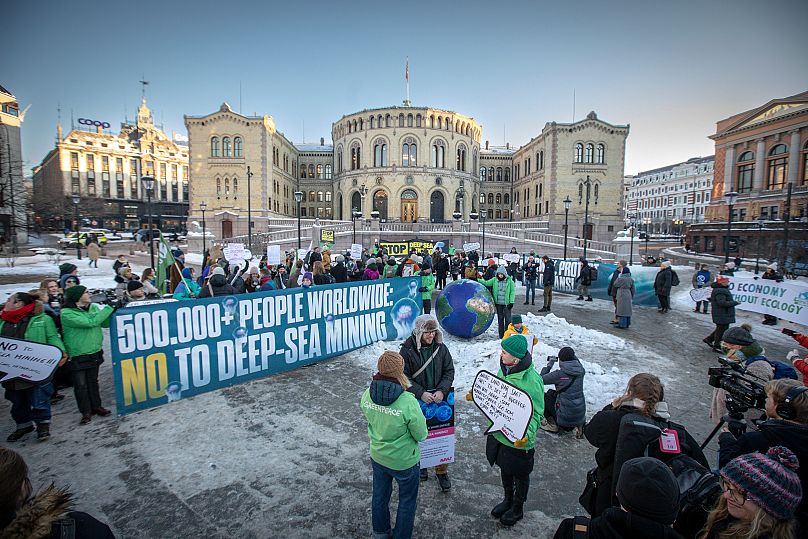 International activists and environmental organisations gather outside the Norwegian Parliament as the vote to approve the opening for deep sea mining was passed.