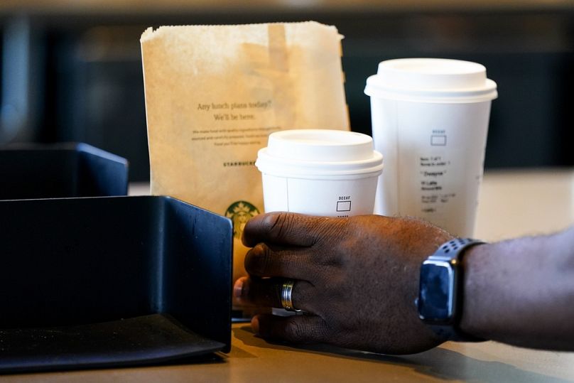 A customer picks up their drink at Starbucks.
