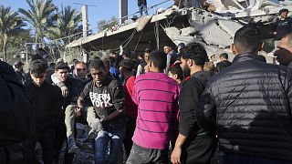 فلسطينيون يقومون بإجلاء الجرحى بعد أن أصابت غارة إسرائيلية مبنى مجاور لمستشفى الأقصى في دير البلح
